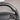 Carbon fiber steering wheel side detail with black perforated grip and control buttons