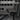 Adjustable support leg on cargo divider with MOLLE grid panel