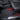 Black ribbed floor mat with molded channels and side cutouts