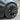 Front wheel with satin black aero-style wheel cover on an 18-inch rim