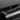 Drawer-style glove box organizer with front slot and open tray, dark gray