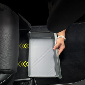 Underseat storage bin being placed under seat, light gray interior tray