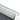 Close-up of underseat storage bin rim with textured grip detail and curved corner