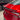 Rear spoiler installed on red car, glossy black aerodynamic lip