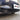 Front bumper grille insert with diamond mesh openings and dark slats, black finish