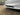 Front bumper side grille insert with black diamond mesh and slatted vent opening