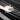 Front trunk sill plate protector with textured grip surface, hand wiping the mat