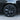Wheel cover close-up on tire, dark multi-spoke design with circular center cap