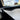 Glossy carbon-fiber door trim strip on interior door panel edge