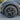 Black wheel cover with turbine spokes and center cap on a tire