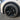 Black wheel cover with multi-spoke turbine design and center cap on a tire