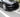 Glossy black ABS front lip spoiler on front bumper with slim grille-style openings
