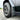 Gray front mud flap beside wheel and tire on Cybertruck, close-up