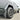 Gray mud flap mounted beside wheel on silver Cybertruck