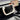 White yoke-style steering wheel with central pad and dashboard screen mount