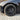 Black multi-spoke wheel cover with center hub on tire, front wheel view
