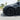 Black multi-spoke wheel cover on a front wheel, angled close view
