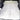 Gray suede-style self-inflating air mattress spread flat in a car trunk
