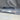 Carbon fiber door sill trim insert with chrome lettering, shown installed on vehicle