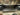 Rear bumper guard panel with mounting holes and rectangular metal opening