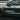 Black graffiti-style decal on a car door with clean, sharp edges