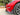 V-style carbon fiber front lip splitter on red sedan front bumper