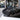 Black carbon fiber wing spoiler overlay with curved leading edge and textured finish