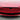 Carbon fiber front bumper inlay on red front fascia with glossy dark V trim