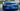 Carbon fiber rear trunk spoiler installed on blue Tesla Model S, rear view