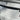 Carbon fiber tailgate trim cover on a silver trunk lid with visible twill weave