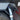 Carbon fiber charge port cover overlay with carbon-weave insert and silver emblem