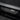 Carbon fiber door sill cover insert with silver emblem, black weave pattern