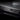 Glossy carbon fiber door sill cover with black weave texture and mounting cutout