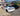 Carbon fiber rear trunk spoiler on white Tesla Model S, rear three-quarter view