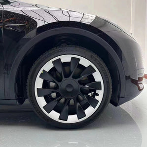 Car wheel with 20-inch rim protector installed, black and silver spokes, red brake caliper