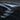 Carbon-fiber style side camera trim covers with dark glossy finish, chrome-like edges