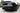 Black rear spoiler lip and diffuser-style bumper trim with exhaust cutouts