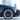 Black multi-spoke 18-inch wheel cover on front wheel with tire installed