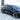 18-inch black multi-spoke wheel cover on car wheel, side profile view