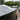 Black carbon fiber rear spoiler on a light-colored car trunk