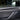 Carbon fiber front door trim cover with dark woven pattern and slim edge