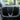 Heated steering wheel yoke with black carbon fiber grips and central steering cover