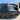Close-up of rear bumper diffuser with red LED brake light and black fins.