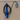 Coiled charging cable in black EV holder on wall; blue cloth tied to cable