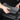 Gray armrest cover and rear screen upper cover held by hands for installation