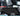 Black roof sunshade panel covering vehicle cab ceiling