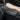 Black armrest cover with stitched edges and a contoured seat insert