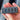 Four-port USB hub held in a hand, with one blue USB port and textured gray-black face