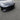 Glossy black ABS front lip spoiler detail on front bumper with split-piece lines