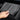 Hands inserting a gray silicone anti-slip dock liner into a vehicle center console